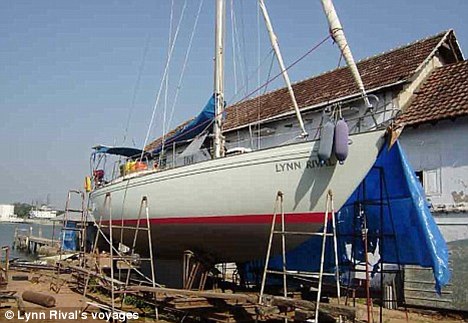 Deserted: The Chandlers' 38ft yacht Lynn Rival, pictured here being fixed before their ill-fated trip, was found abandoned by Royal Navy forces patrolling the pirate-infested waters off Somalia