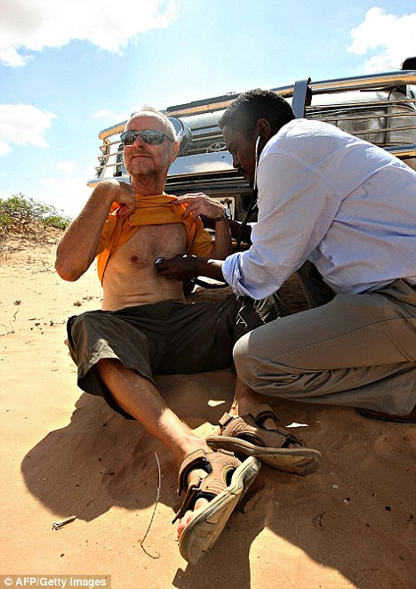 Paul Chandler is examined by the Somali doctor: The pair are being held in separate locations in rugged areas between the coastal village of Elhur and the small town of Amara 